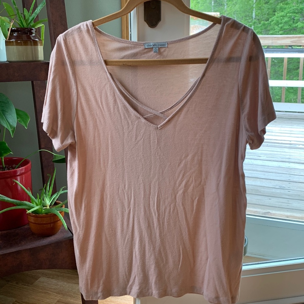 Light pink v-neck stretchy short sleeve shirt with cross over straps on chest